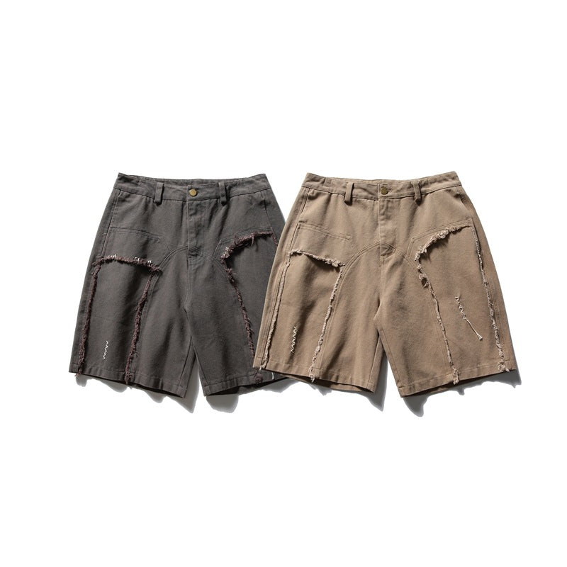 Two pairs of shorts displayed flat, in charcoal and taupe, with curved frayed panel seams.