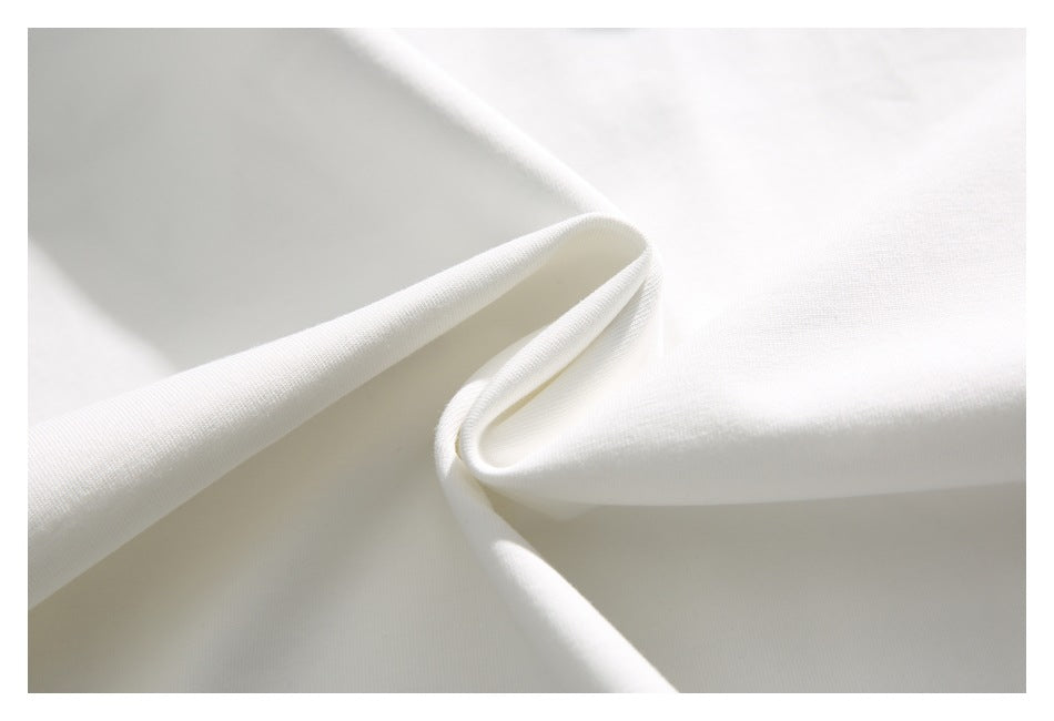 Close-up of plain white fabric folded to show its surface and drape.