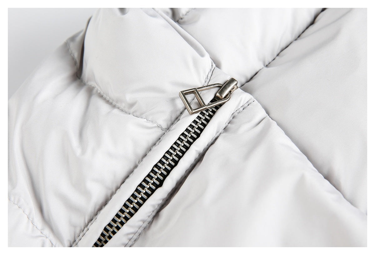 Close-up of the light gray puffer jacket's metal zipper pull and teeth.