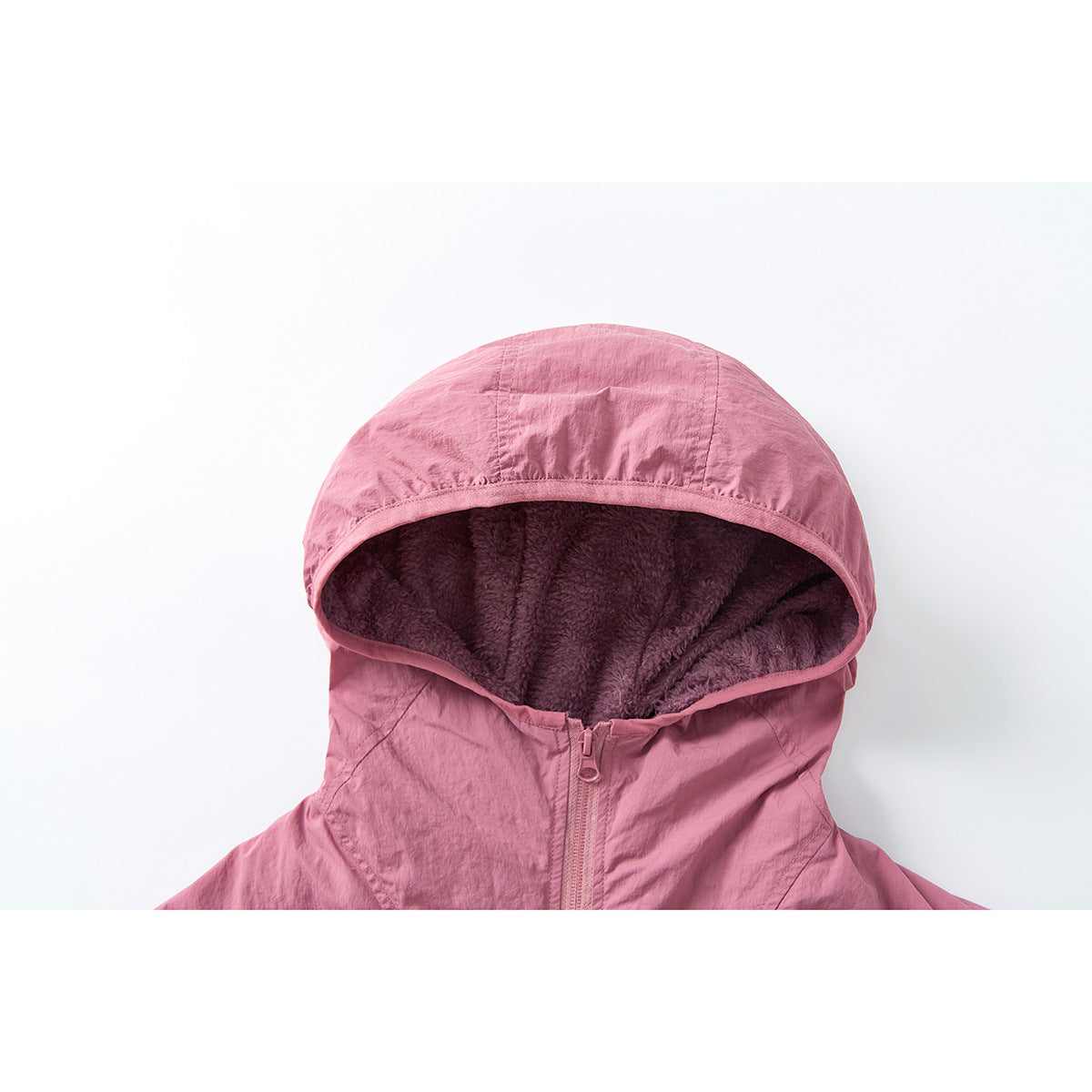 Close-up of a pink jacket hood showing dark plush lining and the front zipper.