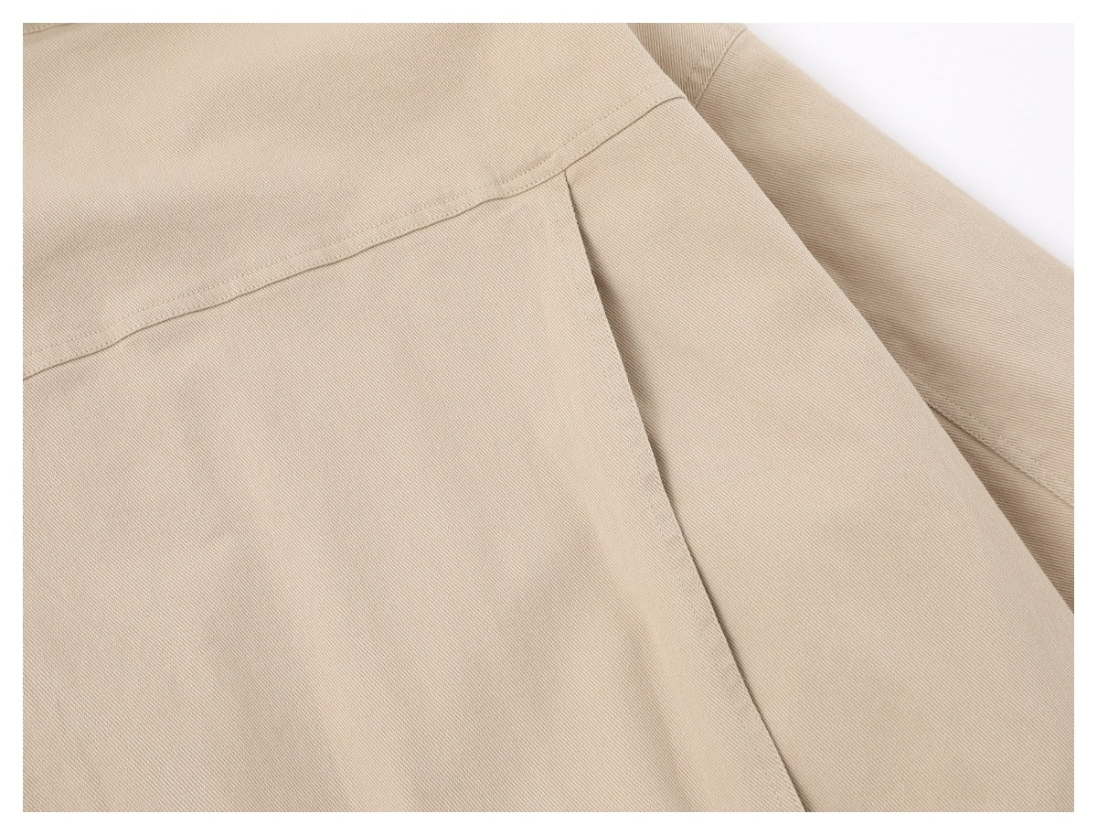 Close-up of the beige jacket's back yoke seam and sleeve.