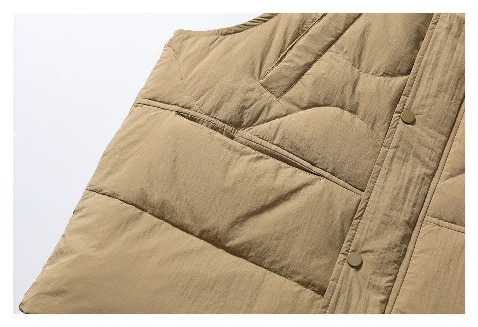 Close-up of the tan vest's quilted lower panel, stitching, and snap-front placket.