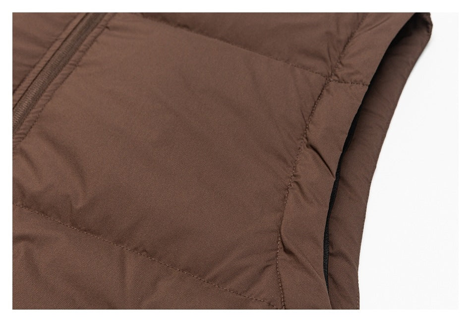 Close-up of a brown garment's side seam and black-edged arm opening.