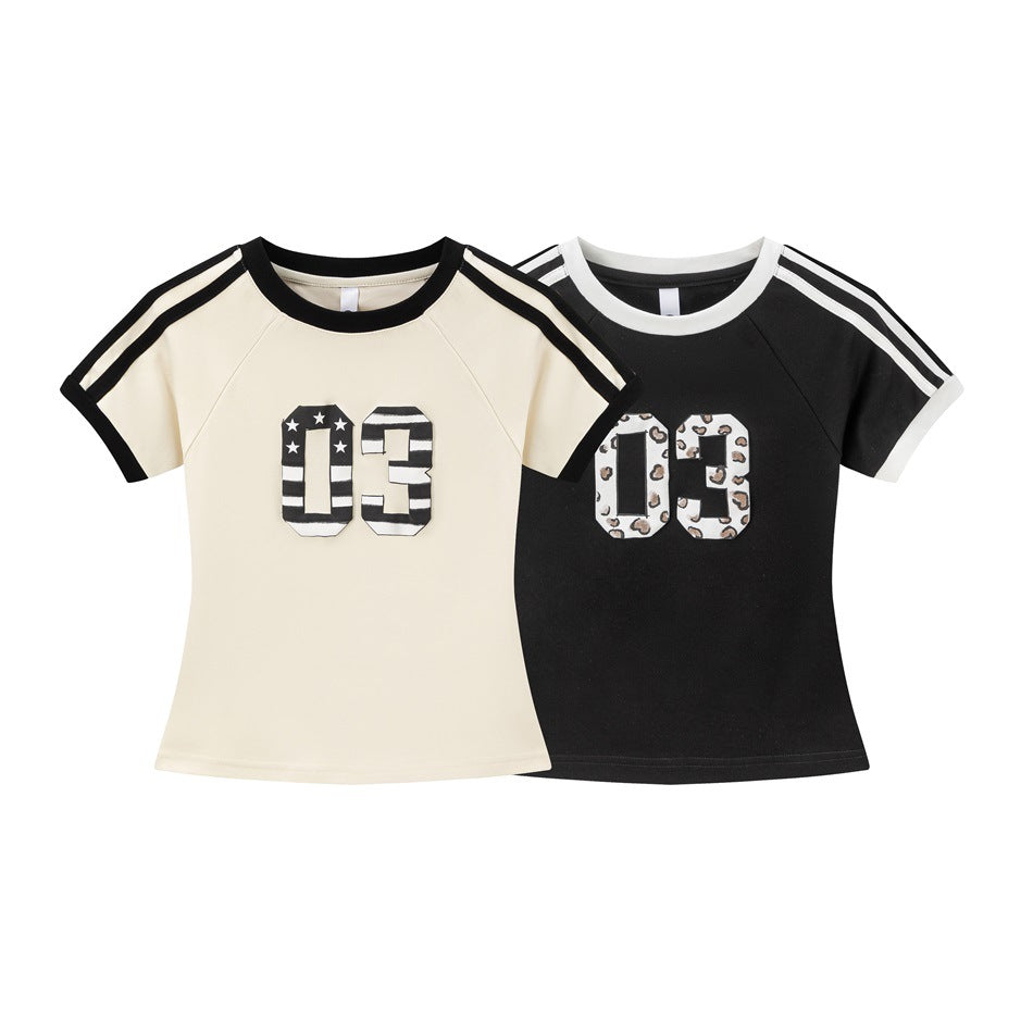 Two short-sleeve raglan tees: cream with black trim and striped 03 applique, and black with white trim and patterned 03