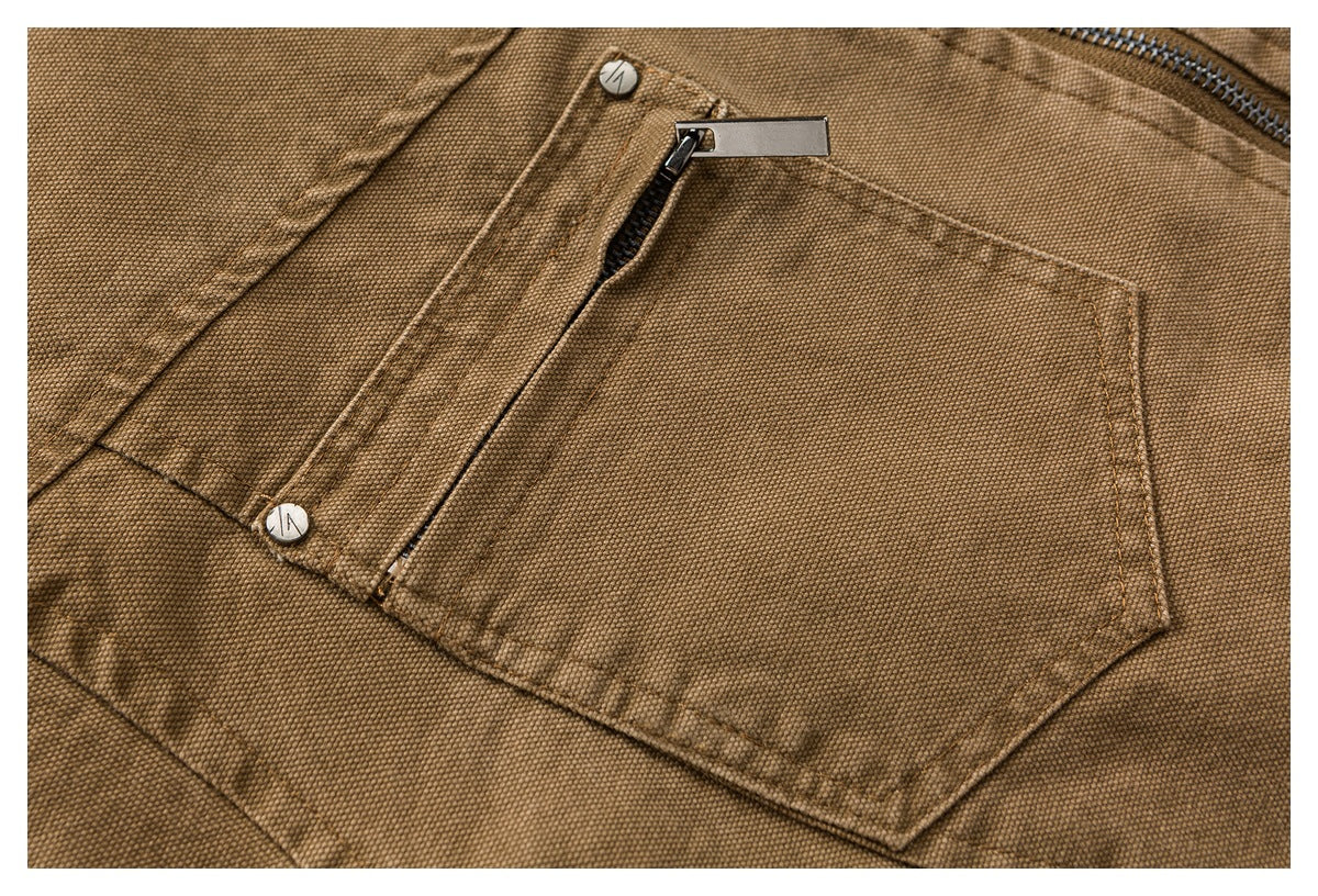 Close-up of a brown textured jacket pocket with a zipper, metal snaps, and stitched seams.