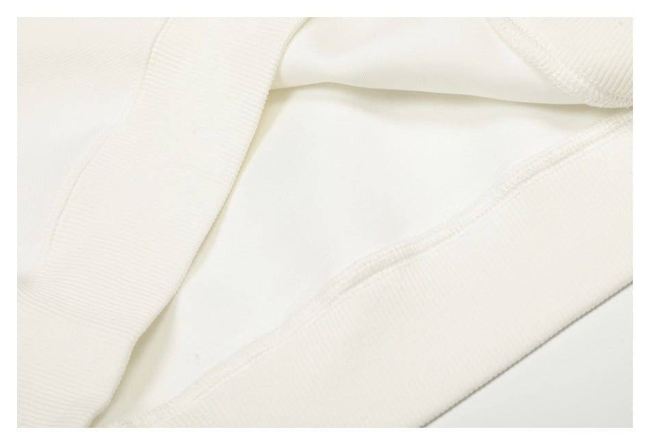 Close-up of the white garment's interior fabric and stitched edge.