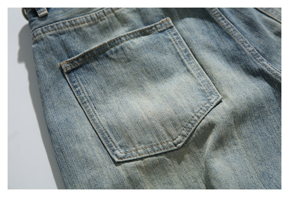 Close-up of the back of faded blue jeans, showing a single rectangular patch pocket with contrast stitching.