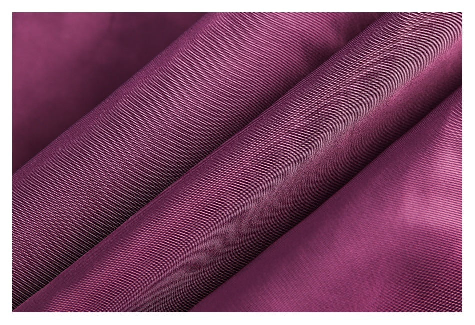 Close-up of plum-purple fabric arranged in soft diagonal folds, showing a fine woven texture.