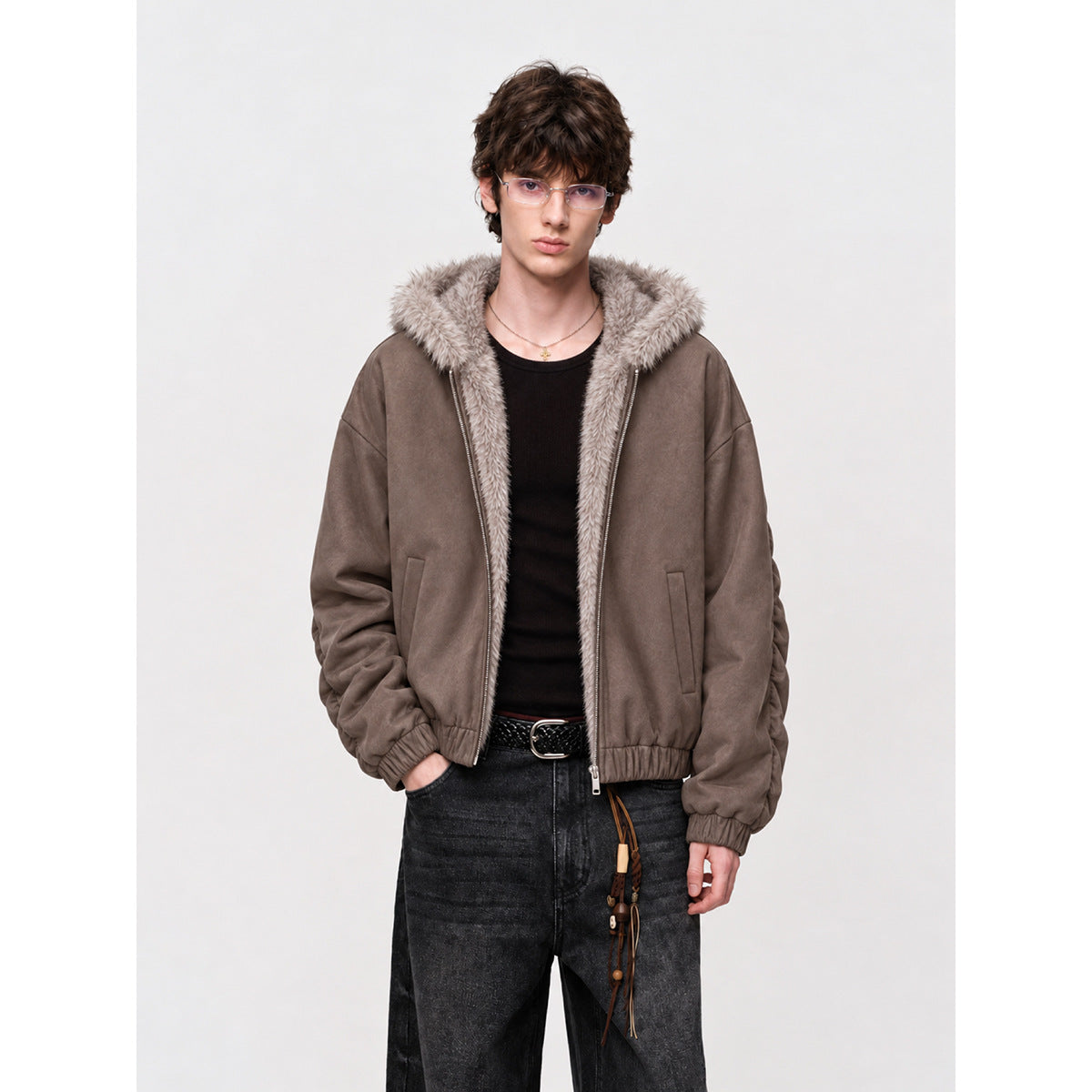 Man wearing a taupe zip-front hooded jacket with pale faux-fur trim and gathered sleeves.