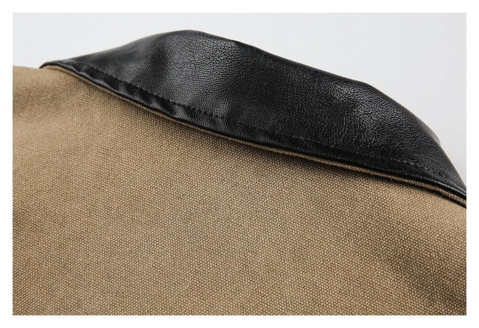 Close-up of a black textured collar panel against tan woven garment fabric.