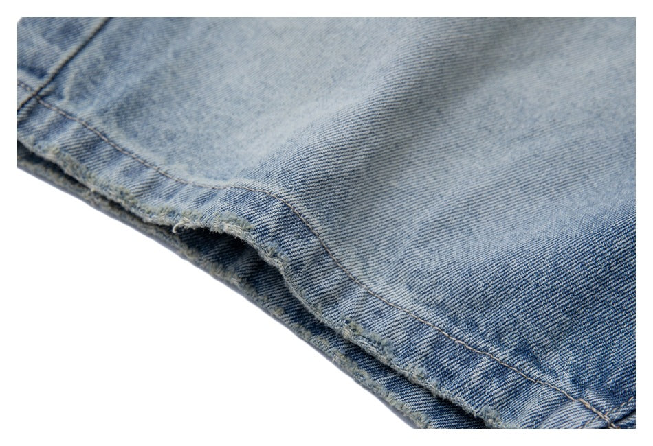 Close-up of the light blue jeans leg hem, showing its stitched edge and lightly frayed finish.