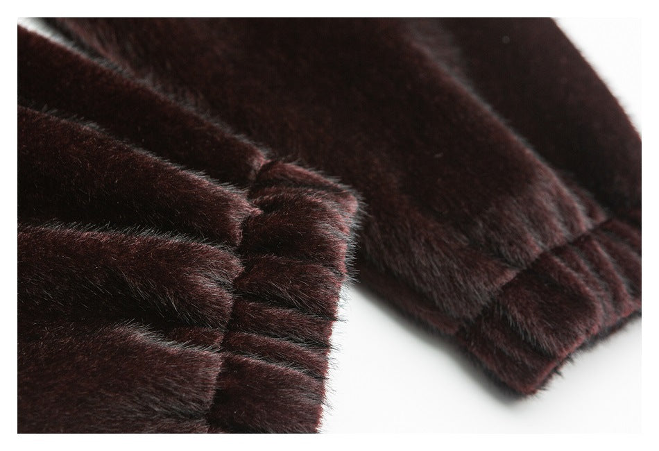 Close-up of a dark burgundy plush sleeve cuff with gathered stitching and a finished edge.