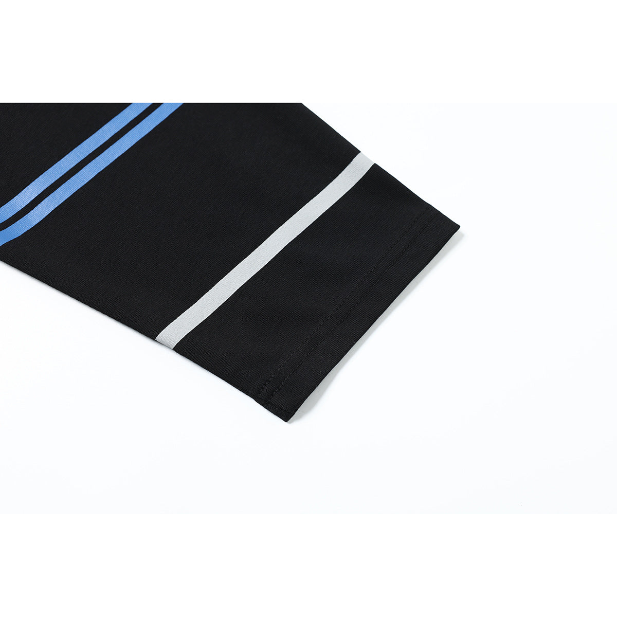Close-up of a black shirt sleeve hem with blue and white stripes.