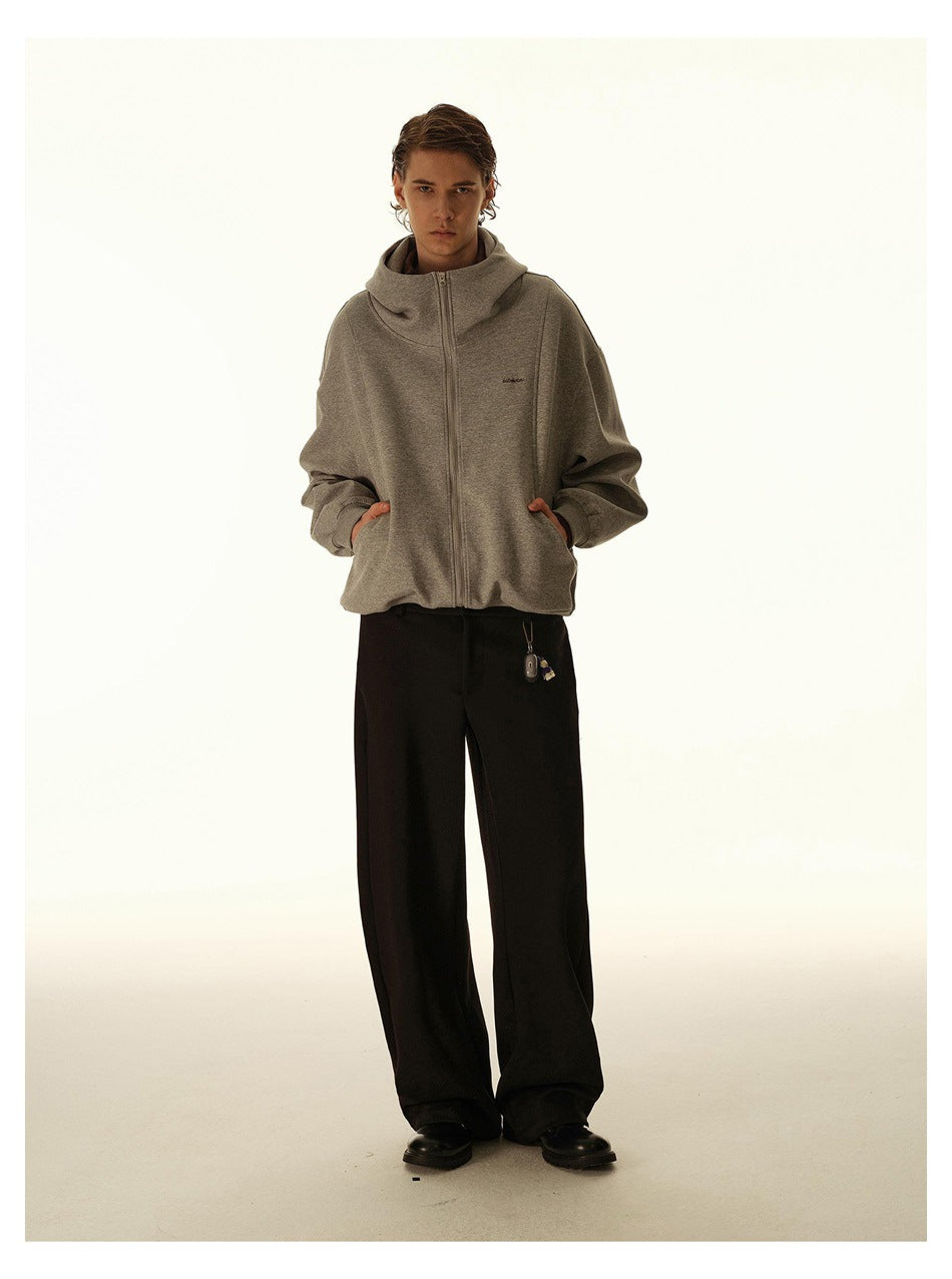 Front-facing model wearing a gray zip-up hooded jacket with black wide-leg trousers.