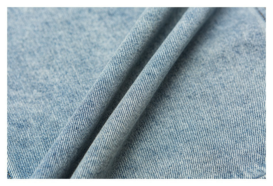 Close-up of the blue-and-white diagonal weave and texture of light-wash denim.