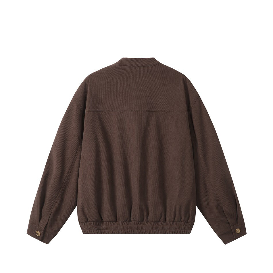 Back view of brown ribbed jacket with yoke seam, elastic hem and button cuffs, flat lay