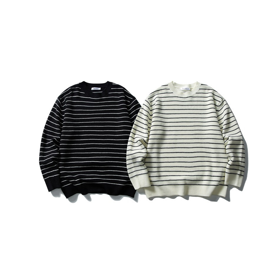 Two striped crewneck sweaters shown side by side: black with white stripes and ivory with black stripes.