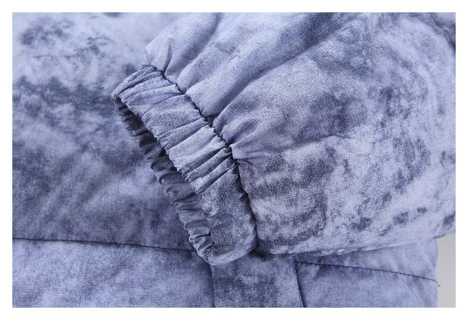Close-up of a gathered elastic cuff on a sleeve of the mottled blue-gray jacket.
