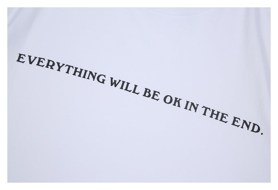 Close-up of the black slogan printed across the white T-shirt front.