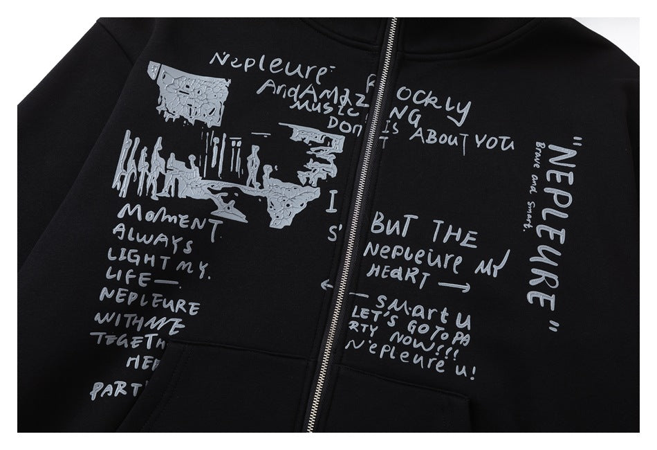 Close-up of a black zip-up hoodie with silver handwritten-style graphic text and illustrations across the front.
