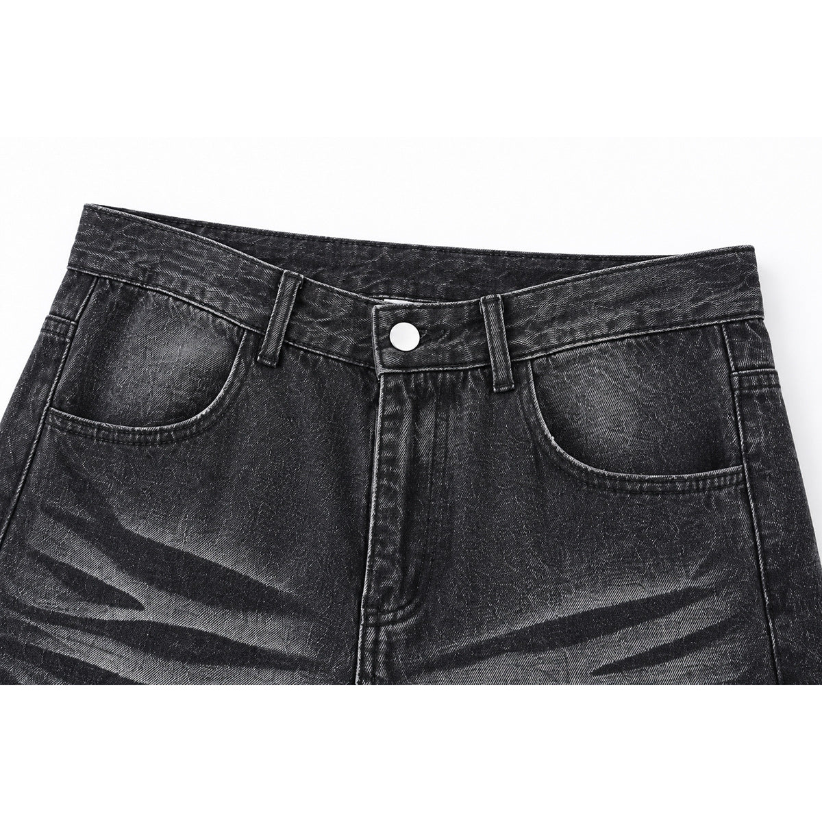 Close-up of the front waistband, pockets, button, and faded stripe pattern on charcoal jeans.