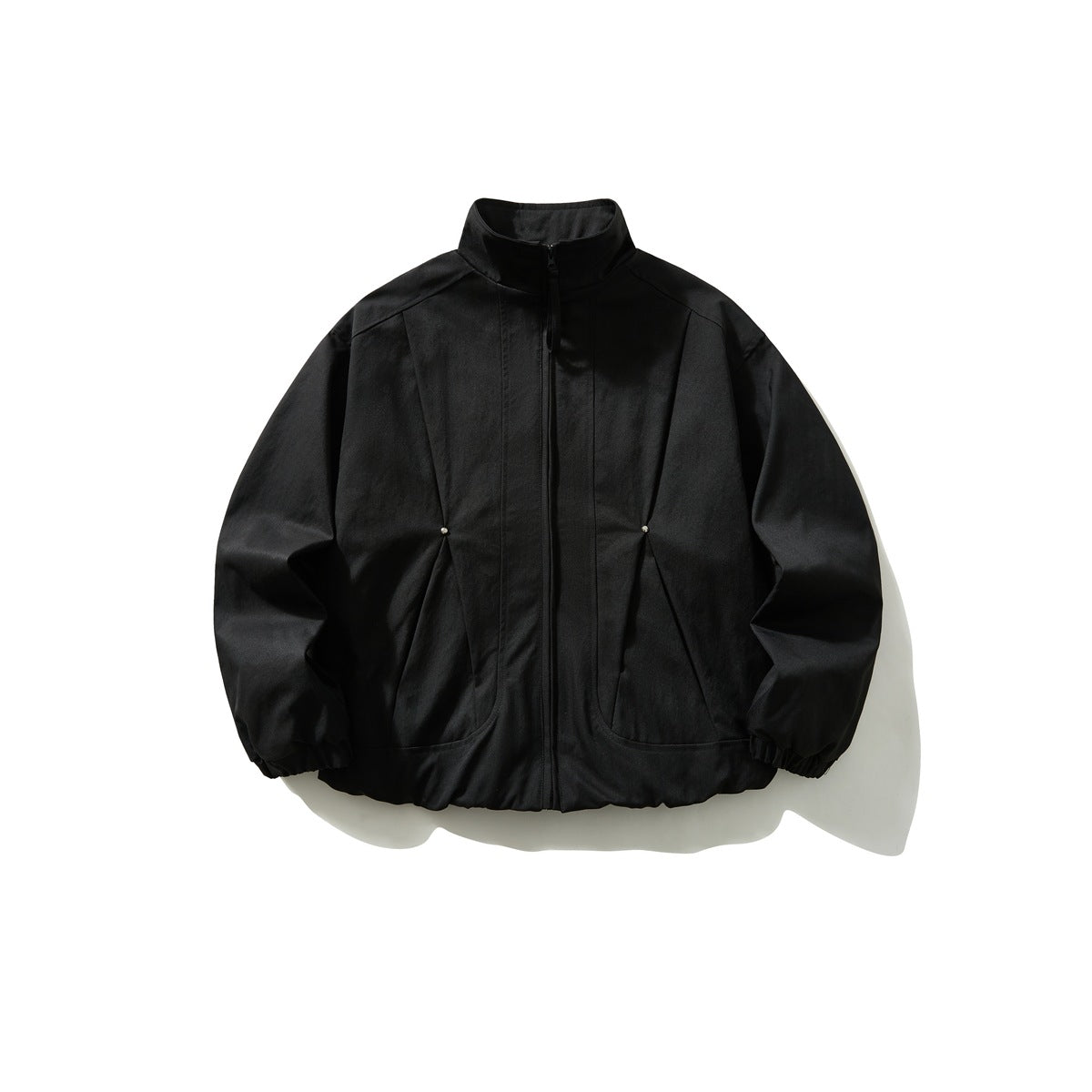 Black stand-collar zip jacket with angled front seams, stud accents, elastic cuffs and hem, flat lay front view