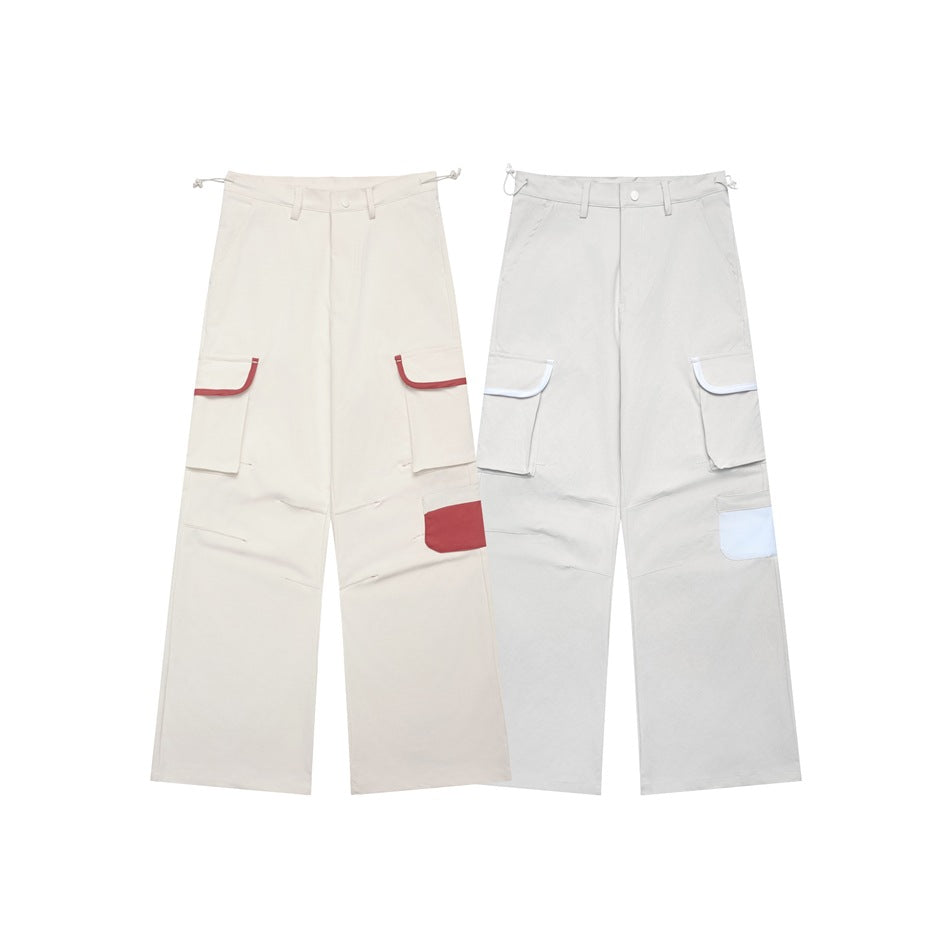 Front view of wide-leg cargo pants in cream and light gray, with contrasting pocket details.