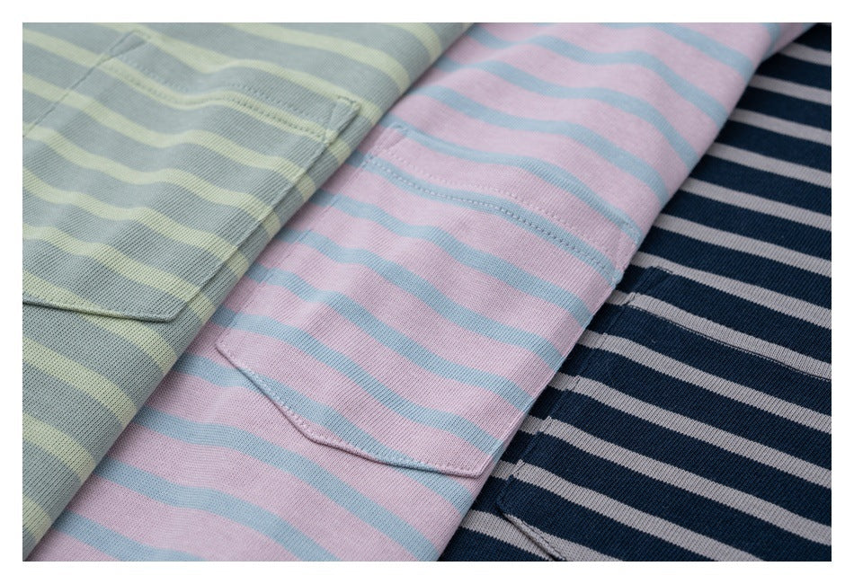 Three striped T-shirts in pale green, pink, and navy, each with a chest pocket.
