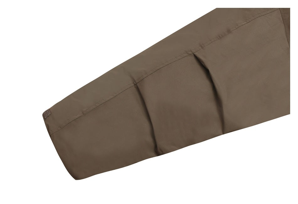 Close-up of a brown garment panel with a stitched edge and two soft folds against a white background.