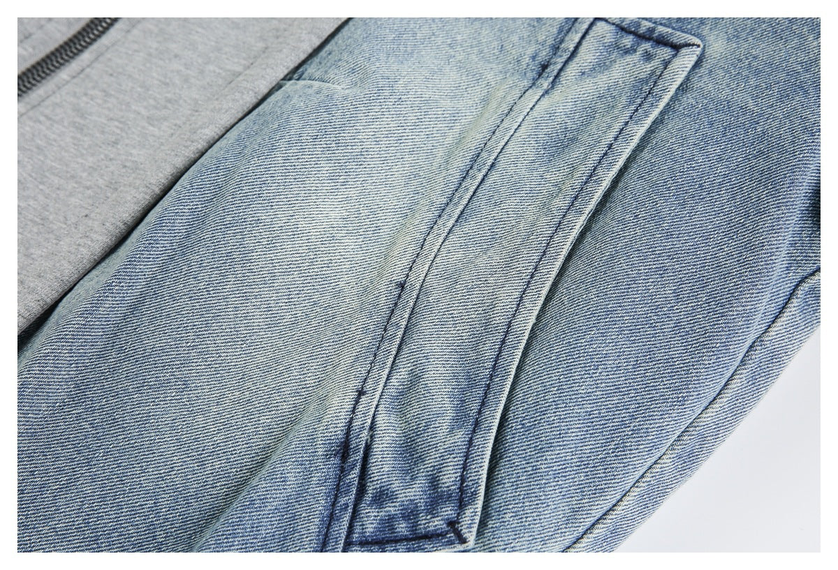 Close-up of a stitched blue denim pocket beside a gray zippered panel.