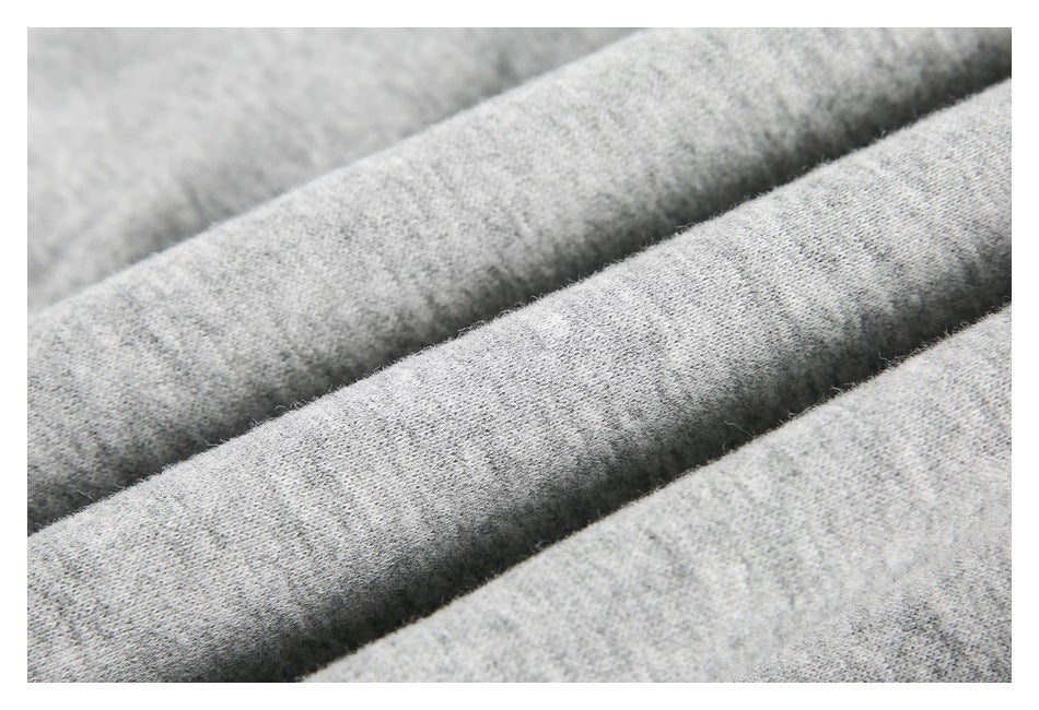 Close-up of light gray heathered fabric arranged in soft folds.