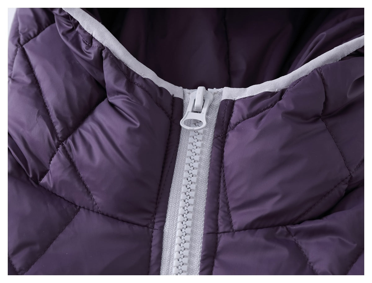 Close-up of the purple quilted jacket's hood trim and chunky light-colored front zipper.