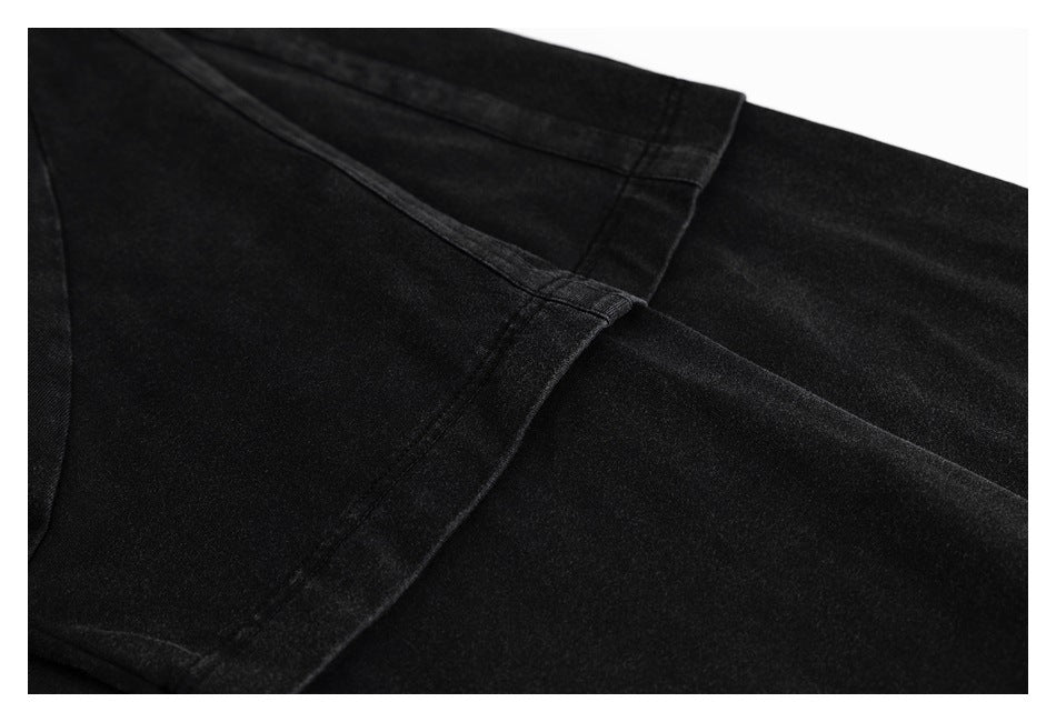 Close-up of black garment panels and intersecting stitched seams.