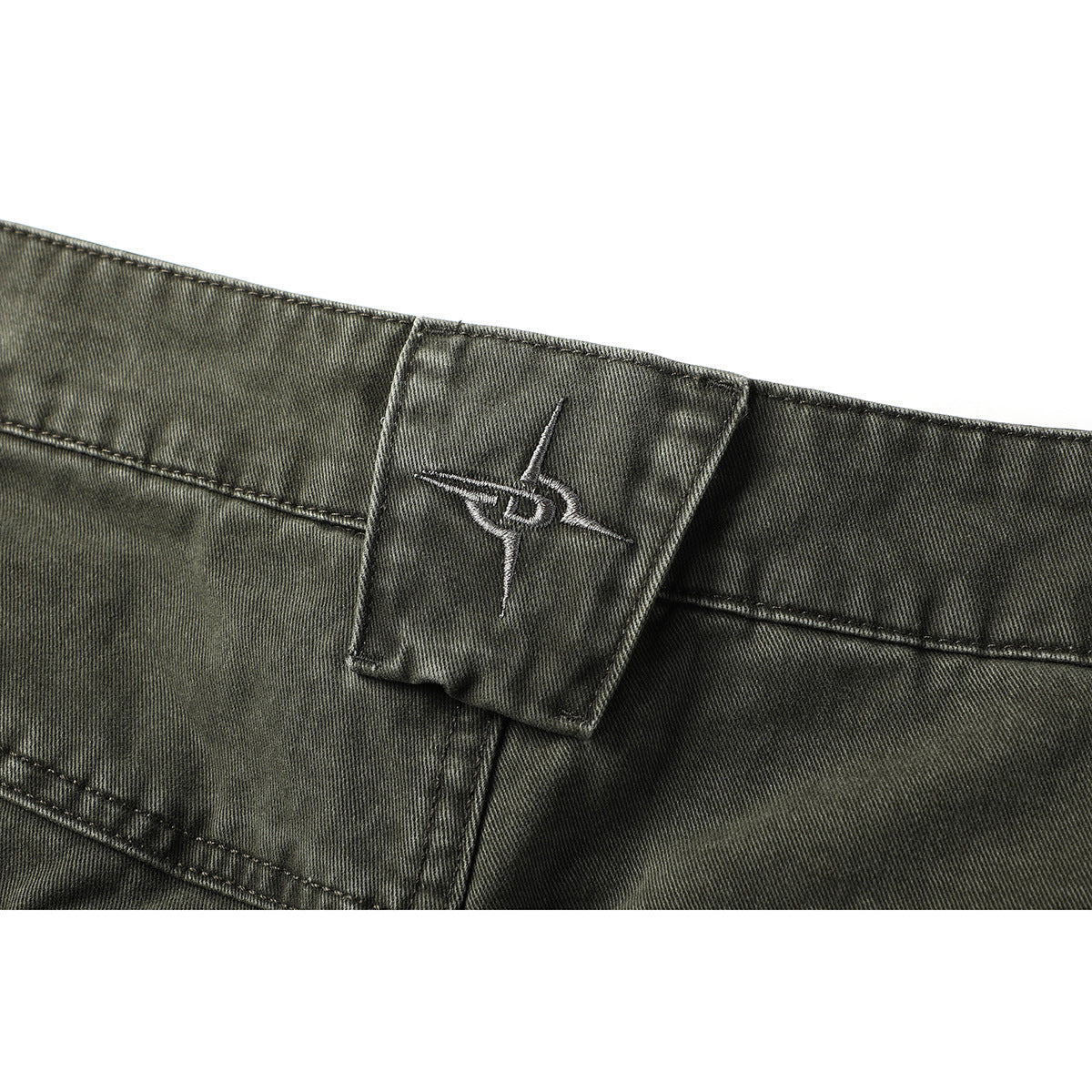 Close-up of the olive-gray pants' back waistband and belt loop with a small embroidered emblem.