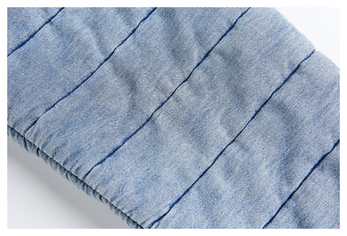 Close-up of parallel quilting and the edge of the light blue jacket.