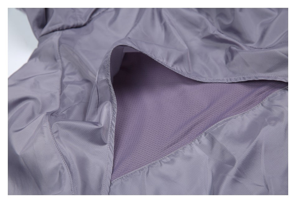 Close-up of a light lavender garment opened to show a darker purple mesh lining and stitched edges.