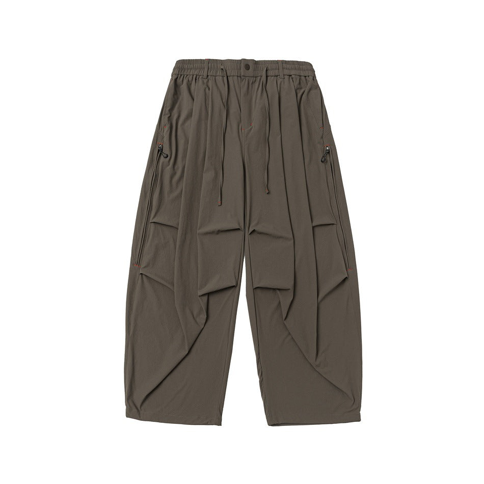 Green olive-brown wide-leg pants, front flat lay with drawstring waist, pleats and zippered side pockets