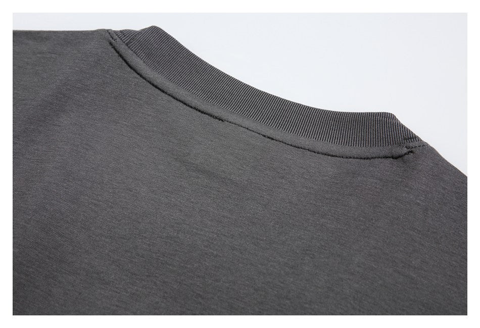 Close-up of the charcoal garment's ribbed crew neckline and shoulder seam.