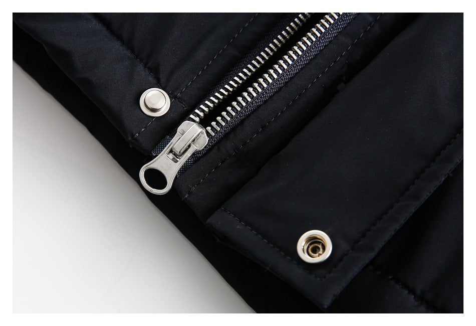 Close-up of a black garment's silver zipper and metal snaps.