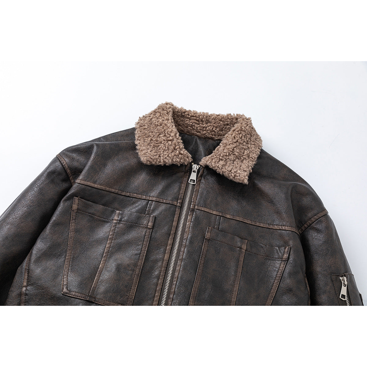 Close view of a dark brown jacket with a taupe sherpa collar, front zip, two chest pockets and a sleeve zip pocket.