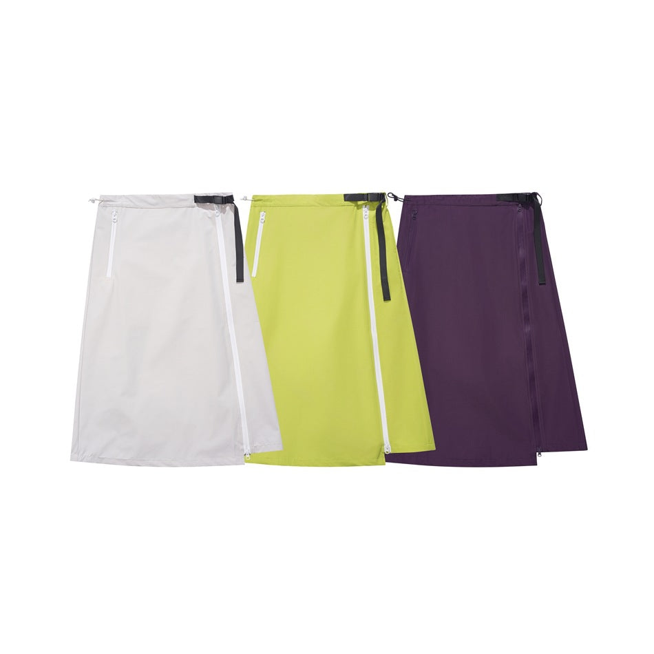 Three skirts displayed together in ivory, lime green, and plum, each with a buckle belt and zip detail.