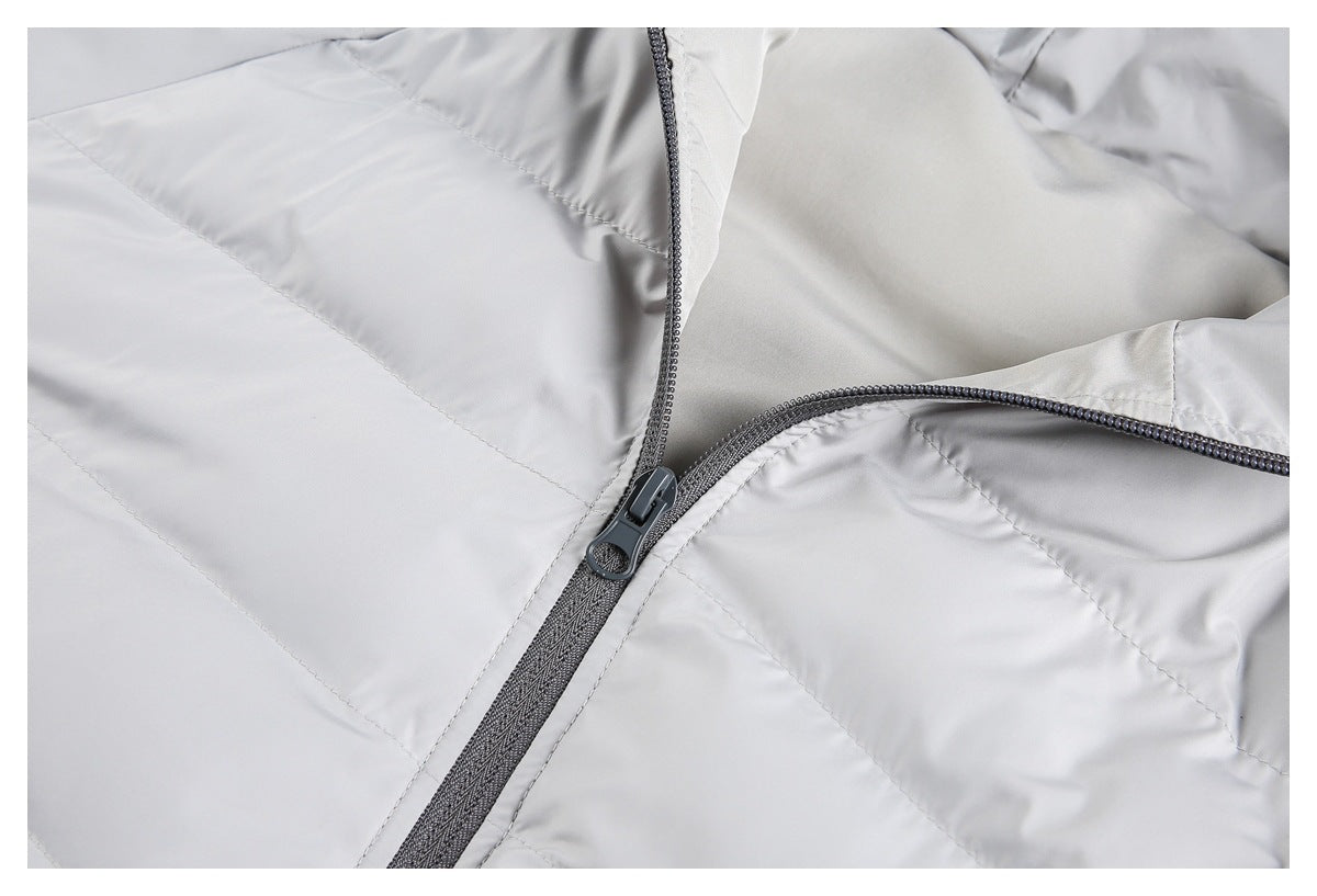 Close-up of the light gray quilted jacket's front zipper and stitching.