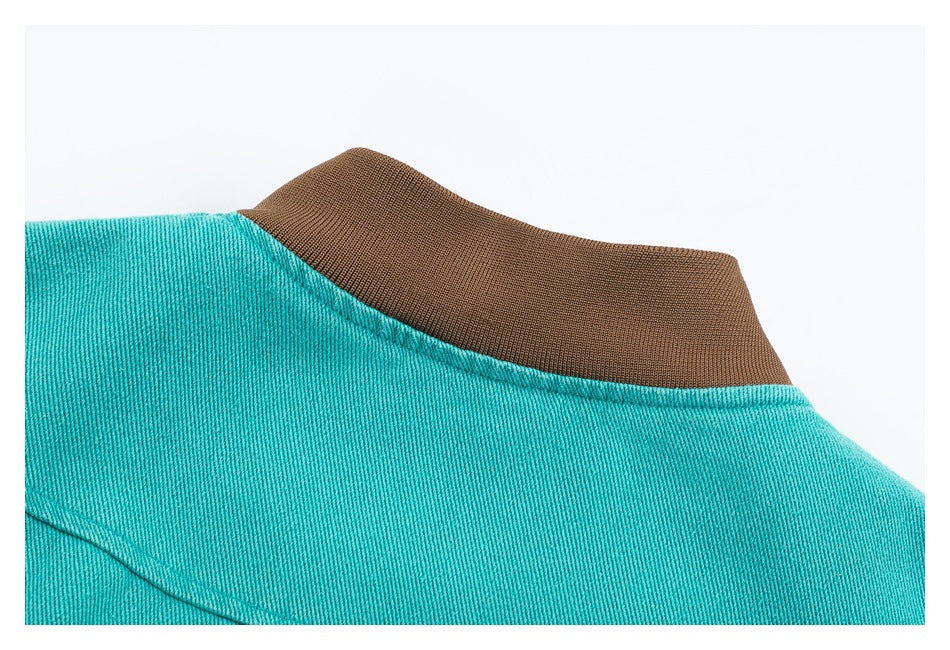 Close-up of the turquoise jacket neckline with a brown ribbed collar.