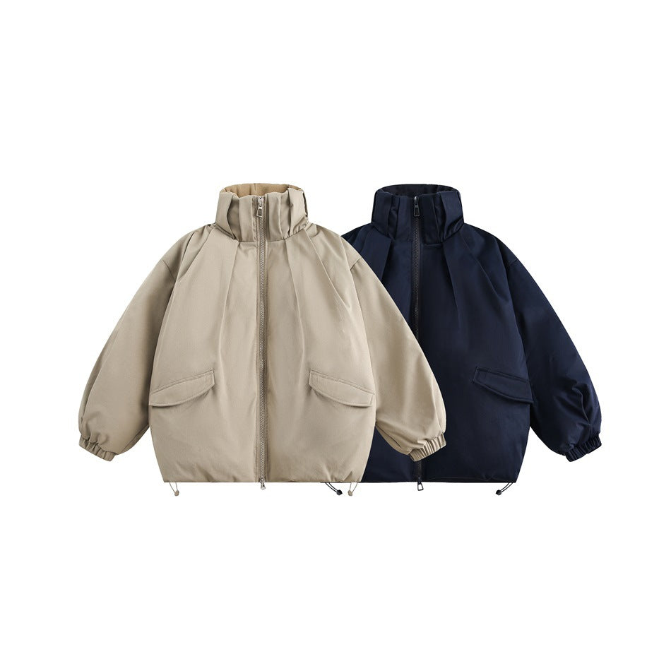 Two front views of oversized zip jackets with tall collars and flap pockets, one taupe and one navy.