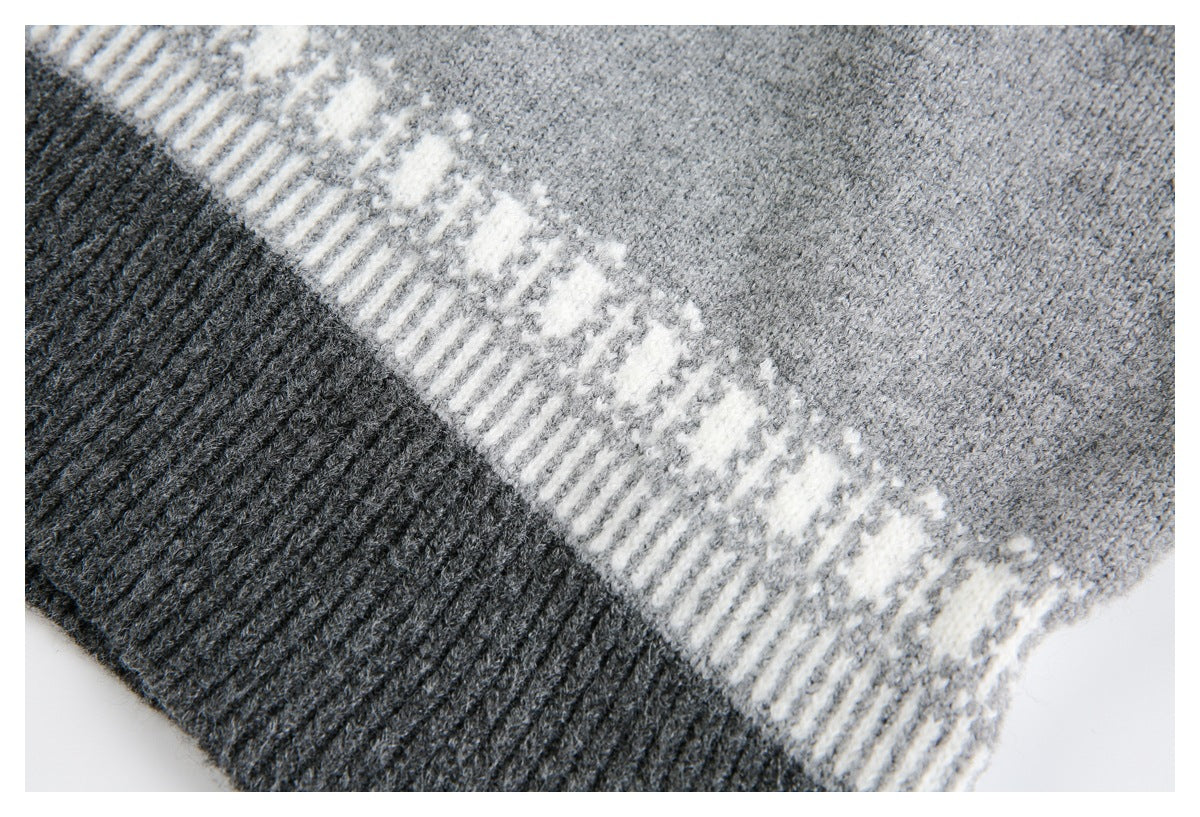 Close-up of gray knit fabric, a cream geometric stripe, and a dark charcoal ribbed edge.