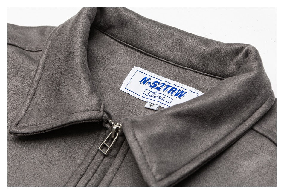 Close-up of the gray jacket’s collar, zipper pull, and sewn neck label.