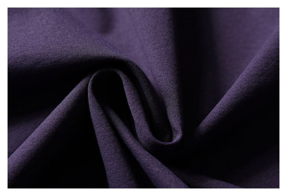 Close-up of folded purple fabric showing its surface texture and soft folds.