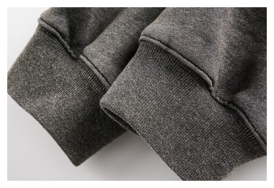 Close-up of two dark gray knit cuffs with ribbed hems.