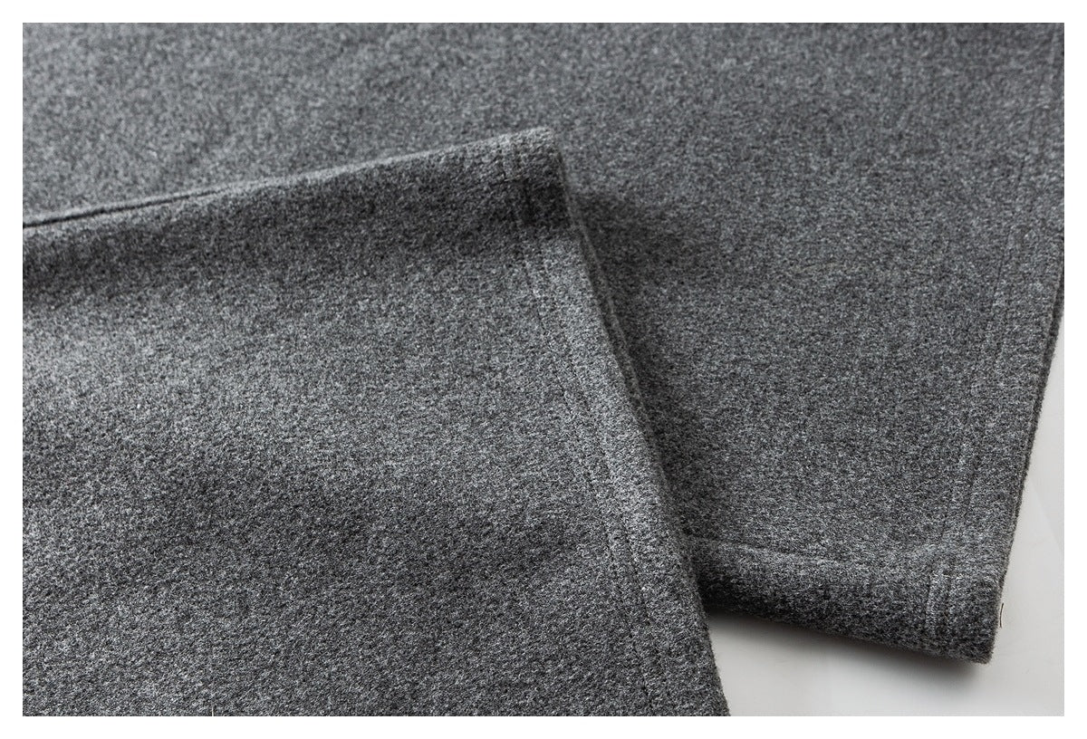 Close-up of charcoal gray trouser legs showing the folded hems and stitching.