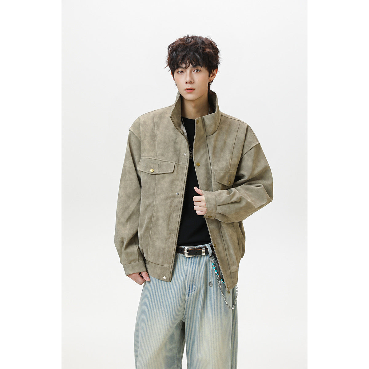 Model wearing a taupe jacket with a high collar, snap-front closure, and flap chest pockets.